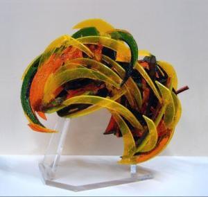 curved sculpture with multi-colors on a clear base