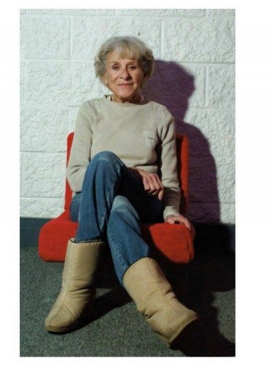 Dorothy Tanner sitting on a chair at the Lumonics Light & Sound Gallery