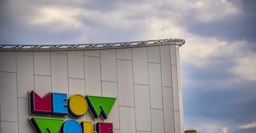 Colorful Meow Wolf logo on the side of the Meow Wolf building in Denver
