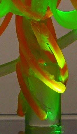 detail of light sculpture with green and amber colors