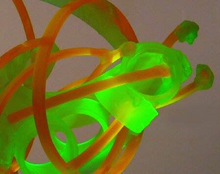 detail of light sculpture with green and amber colors