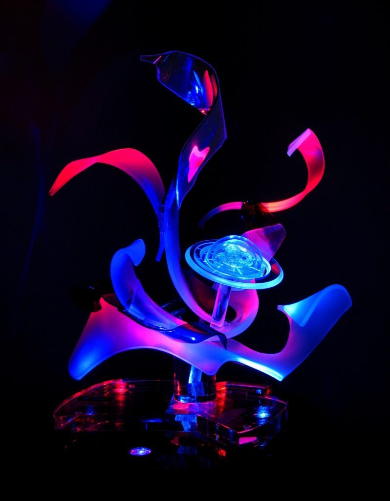 Space Flower sculpture that is red and blue and sandblasted in area